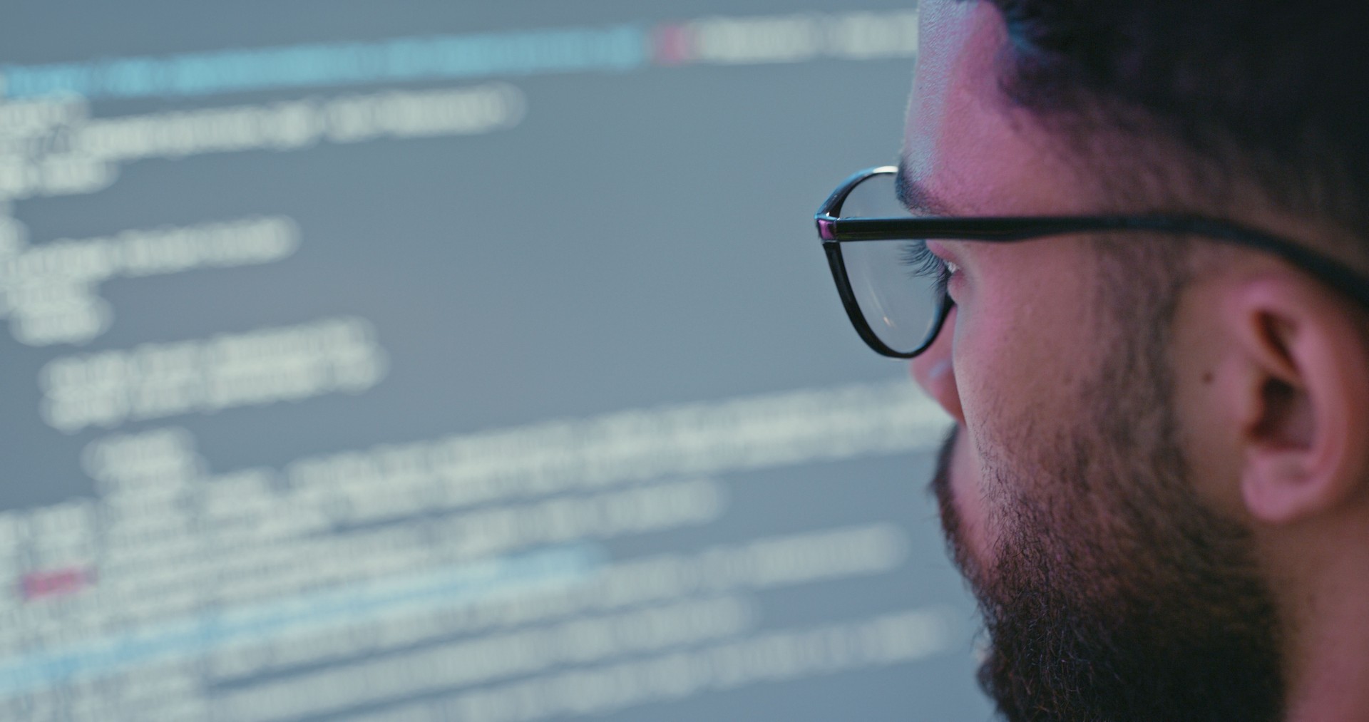 Programer, coding and man reading data on computer for cyber security, programing and source code or script for a digital app. Software developer, coder or it technician at office working on a system